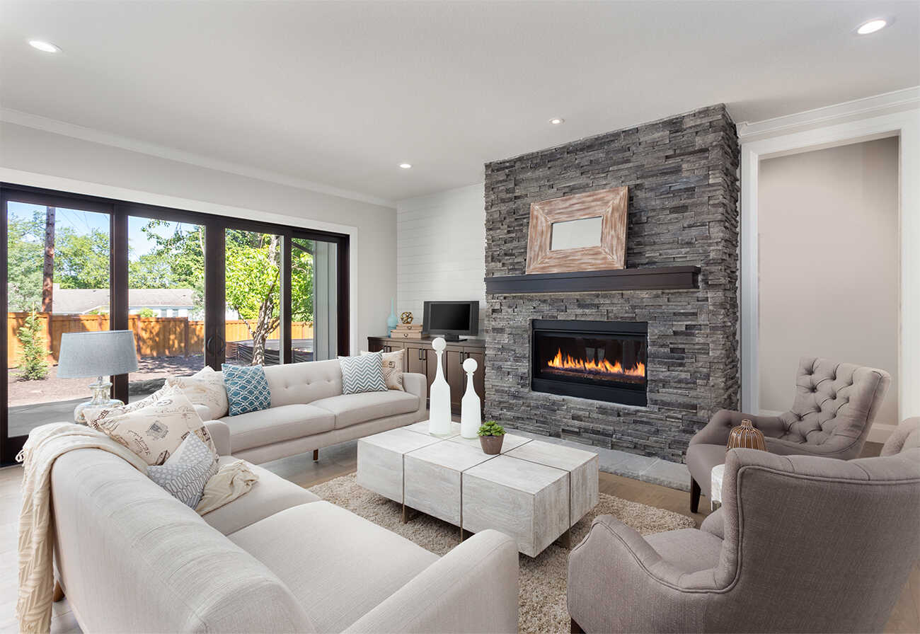 Furnished living room with indoor fireplace.