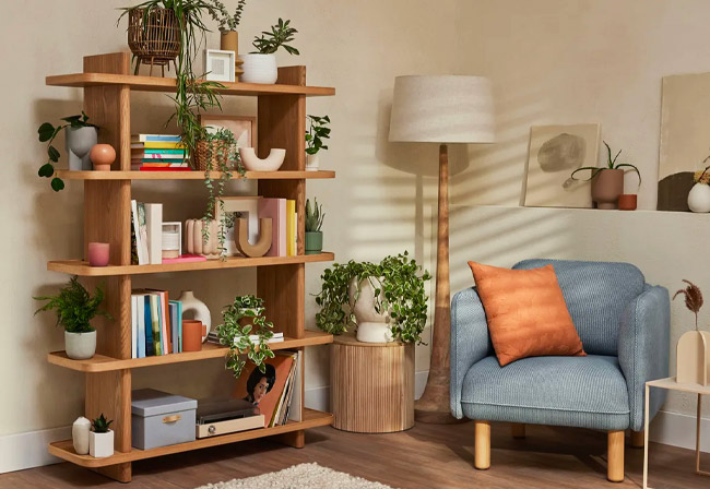 Koala Kirribilli bookshelf in a living room with a blue armchair.