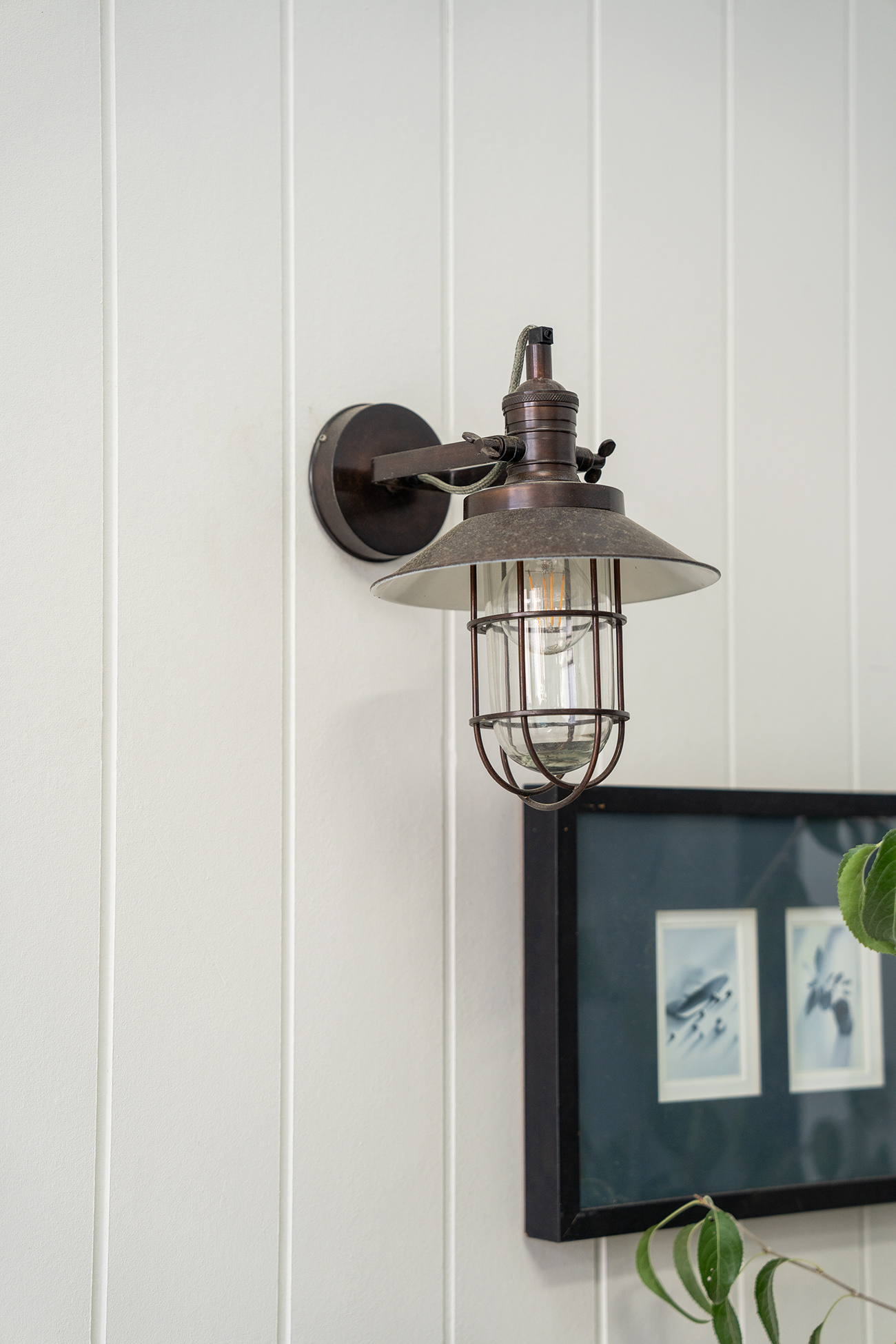 Antique barn light mounted on an outdoor wall.