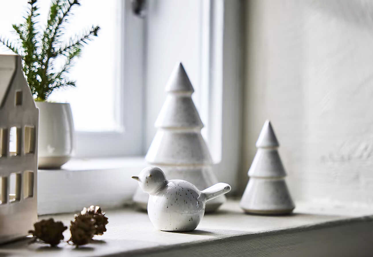 White Christmas decorations on a window ledge.