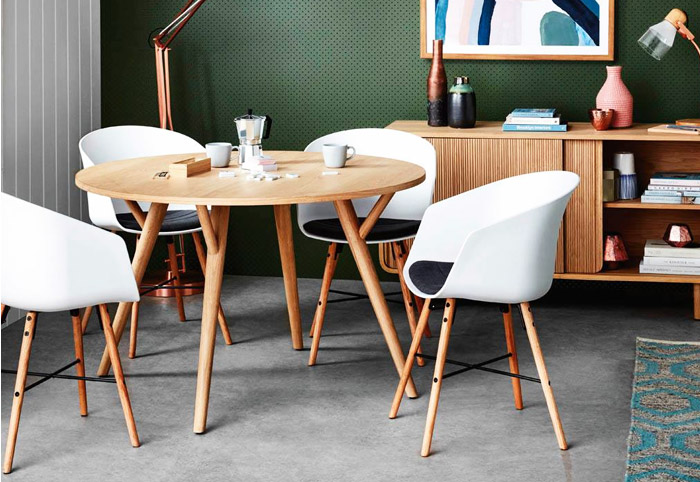 Freedom Piccolo Round Oak Dining Table with four white chairs.