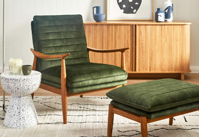 Green mid-century armchair with matching ottoman.