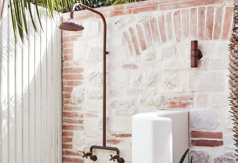 Copper shower in outdoor space.