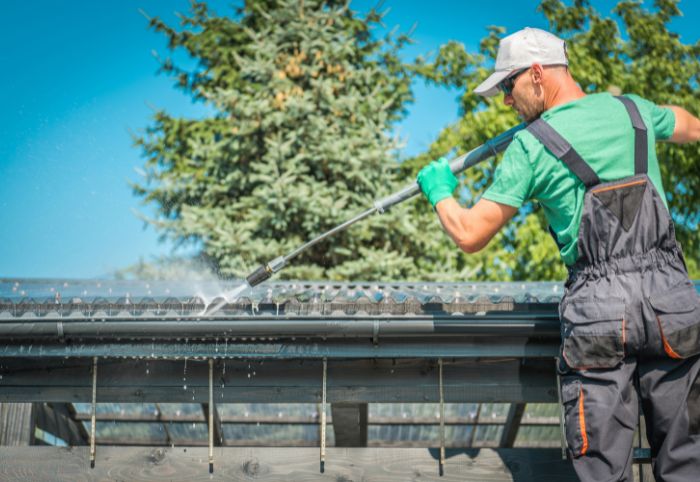 cleaning gutters with a hose