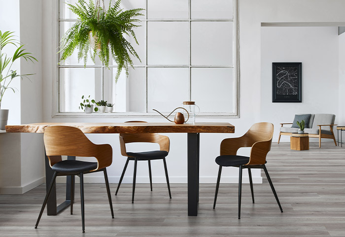 Beaumont Hickory Dublin Isocore Flooring in a minimalist living room with a dining table and hanging ferns.