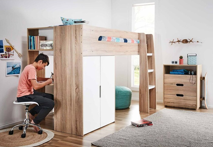 Boy working at a desk built into a raised bed.