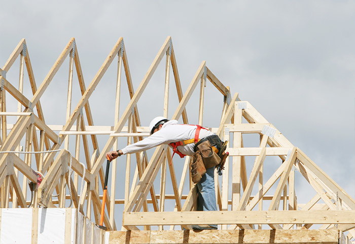 Man building a new roof for a house extension