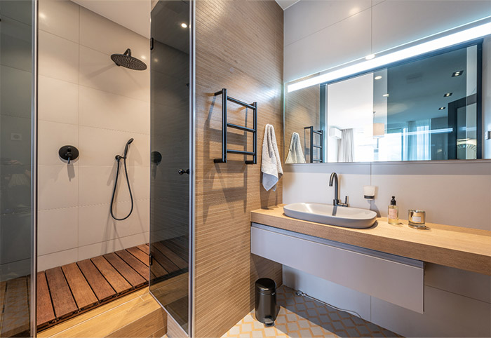 Modern bathroom with overhead vanity lighting