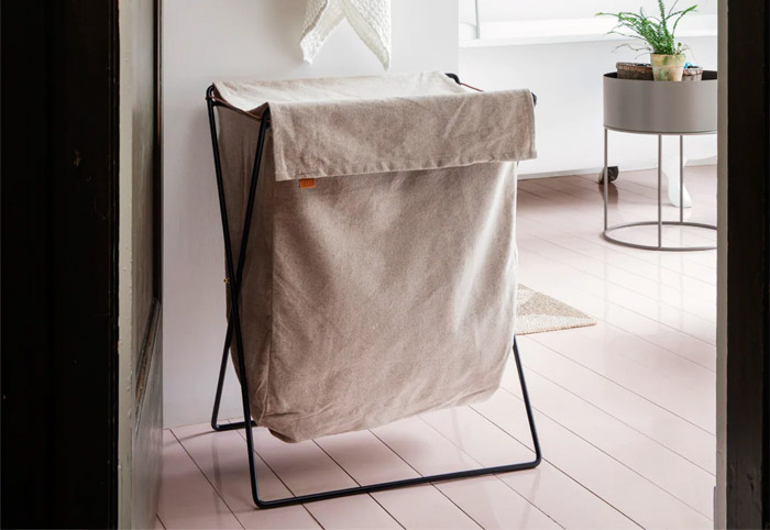 Ferm living Herman laundry stand on a wooden floor.