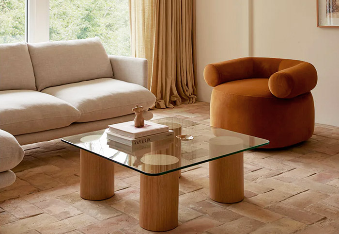 Caramel swivel chair in a living room next to a beige sofa.