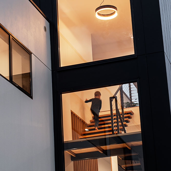 Large windows of a modern three-storey home