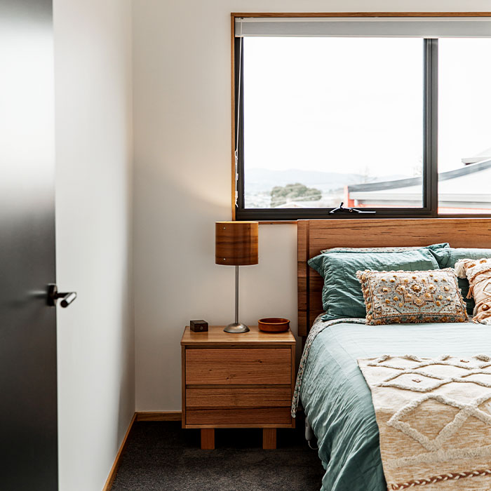 Bedroom showing bed, bedside table and lamp.