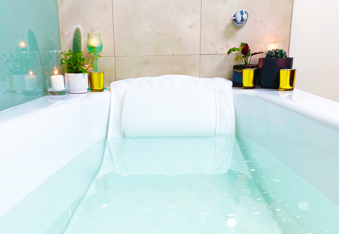 A full length bath pillow submerged in a bathtub.