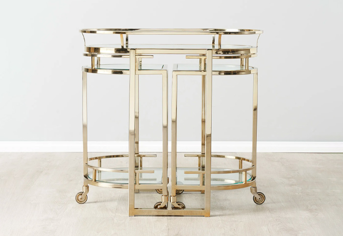 Declan gold bar cart on a wooden floor.