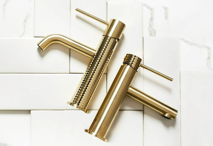 Greens brushed brass basin mixer taps.