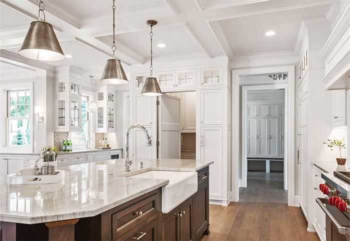 White kitchen with an inset farmhouse sink.