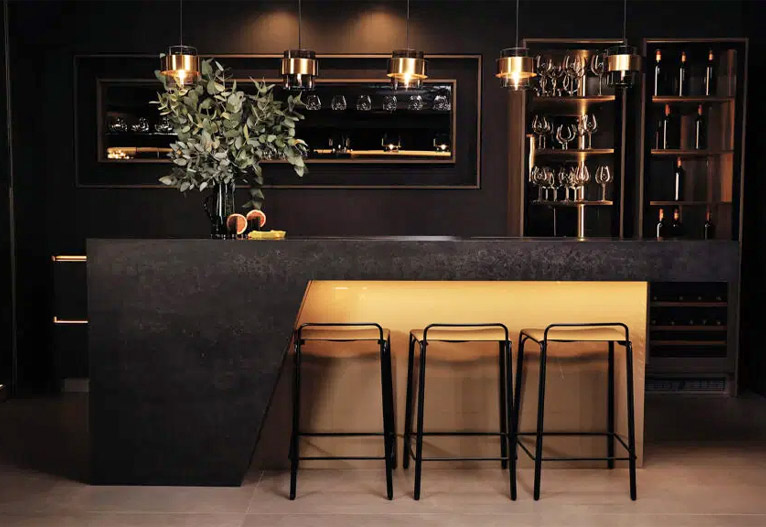 Black waterfall bench in a black kitchen.