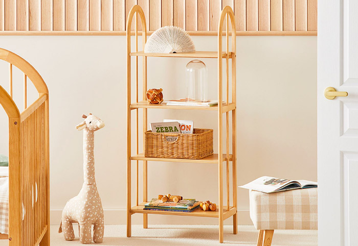 Kids' wooden bookshelf stocked with books and toys.