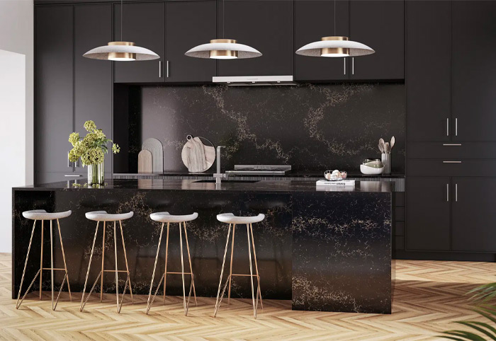 Kitchen with black bench, cabinets and splashback.