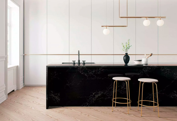 Oversized black stone bench in a white minimalist kitchen.