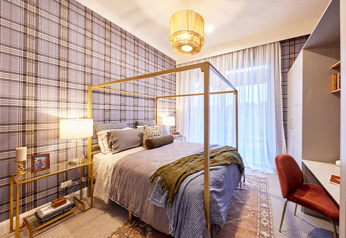 Country-style bedroom with tartan wallpaper.