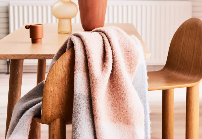 St Albans alpaca throw blanket draped over a wooden chair.