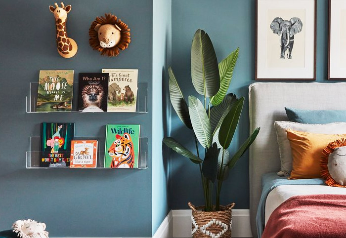 Clear acrylic wall-mounted bookshelves in a child's bedroom.