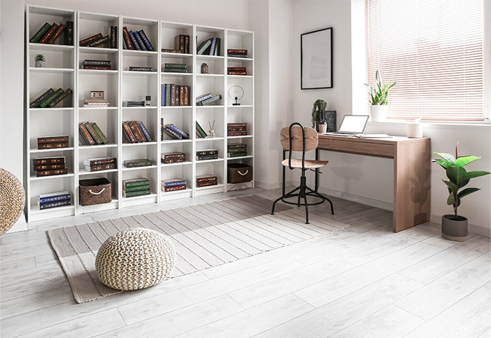 A home study with large open shelves and a timber desk.