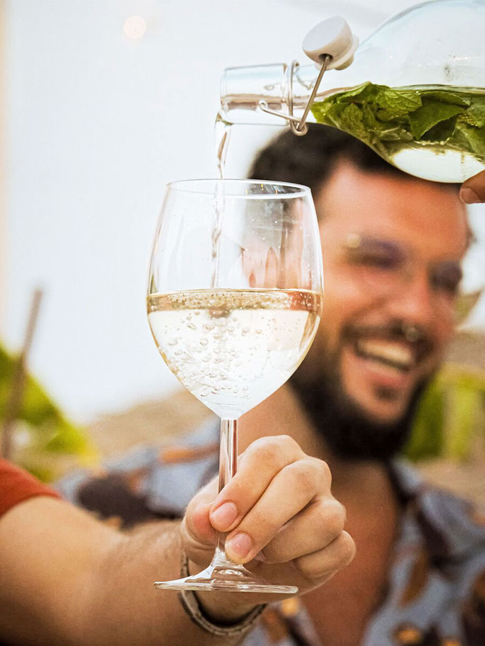 Wine glass being filled in front of a man.