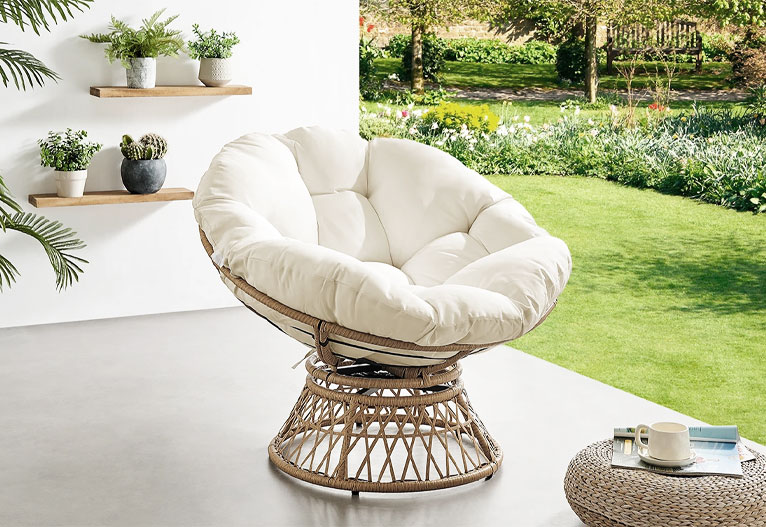 Shangri-La papasan chair on a terrace next to lawn.