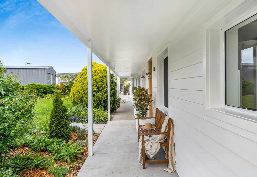 Front porch of a weatherboard house.