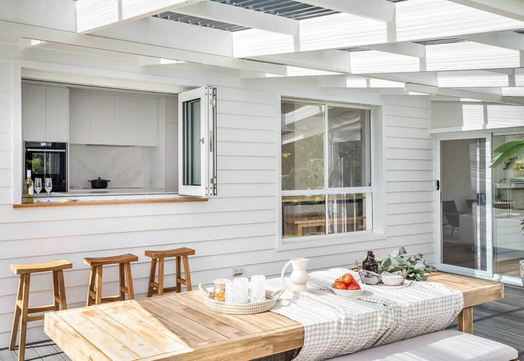 Patio with timber table and picnic food.