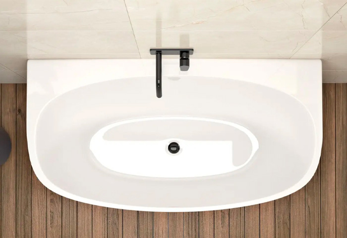 Back-to-wall bath on a wooden floor in a bathroom.