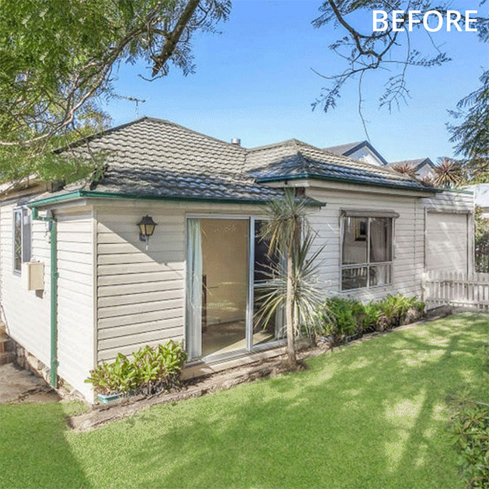 Old Sydney weatherboard house on a small block surrounded by plants.