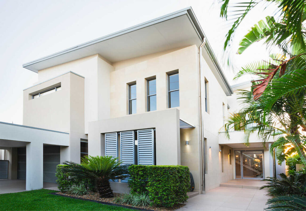 Modern, white, double storey home exterior and entrance.