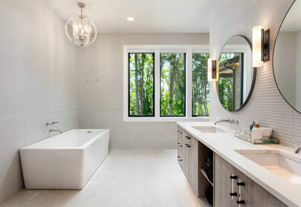 L-Shaped bathroom with a rectangular tub and triple windows.