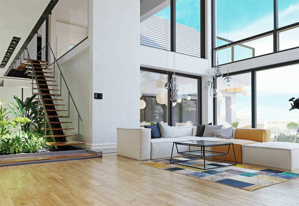 Sitting room of a modern designer house with double windows and a feature staircase.