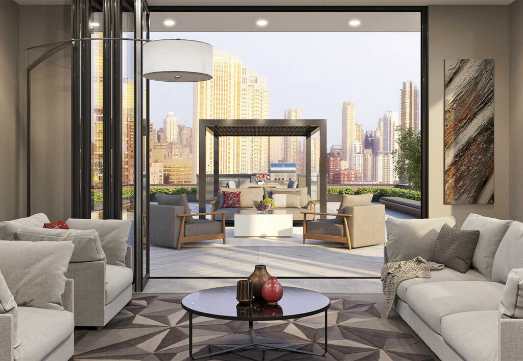 Looking out from the living room of an apartment onto a terrace and city skyline.