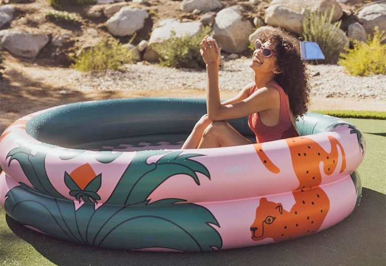 Woman sits in a Pool Boy paddling pool.