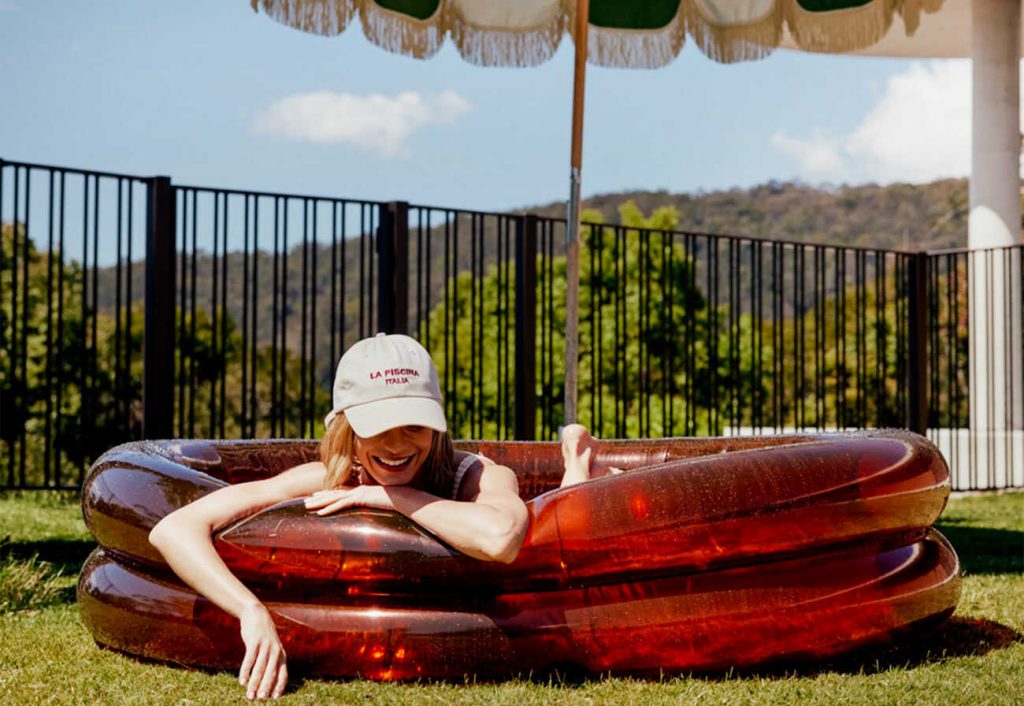 Woman sits in a luxury paddling pool.