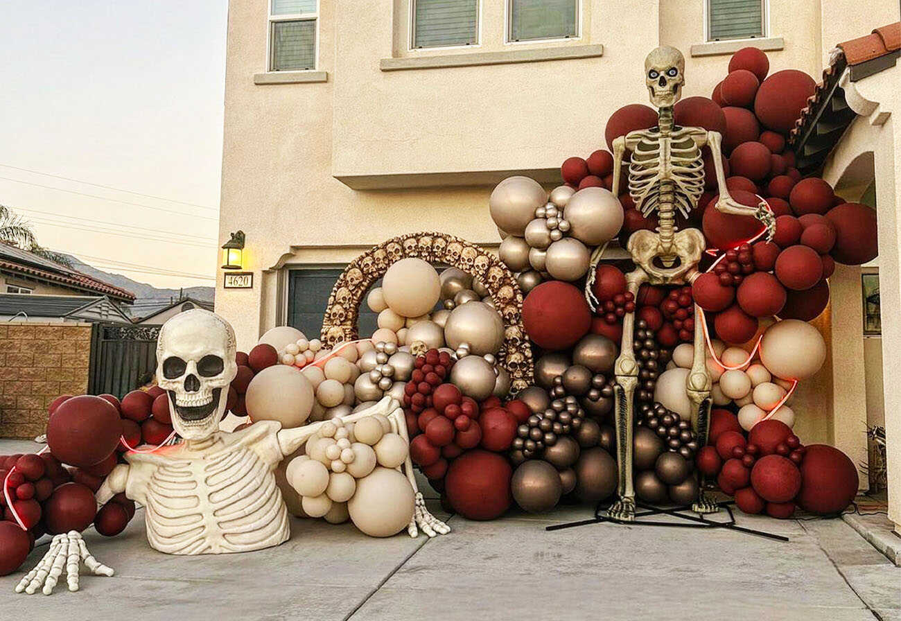 Huge balloon display for Halloween at the entrance to a double-story house.