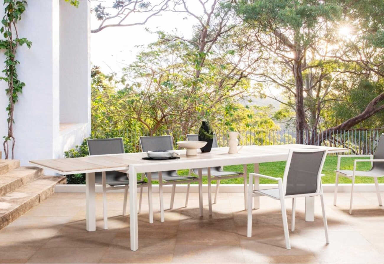 Paved outdoor terrace surrounded by trees. 