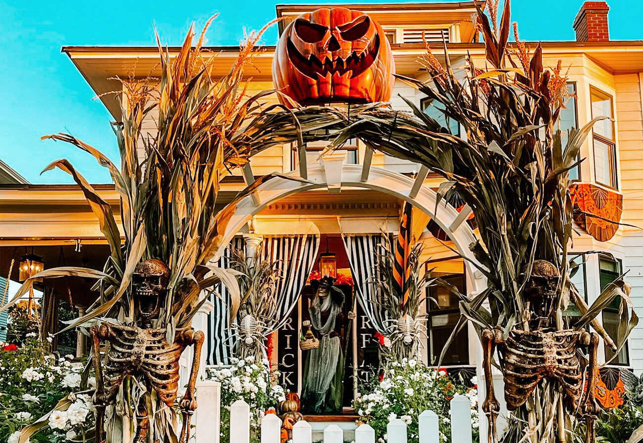 House decorated with skeletons and props for Halloween.