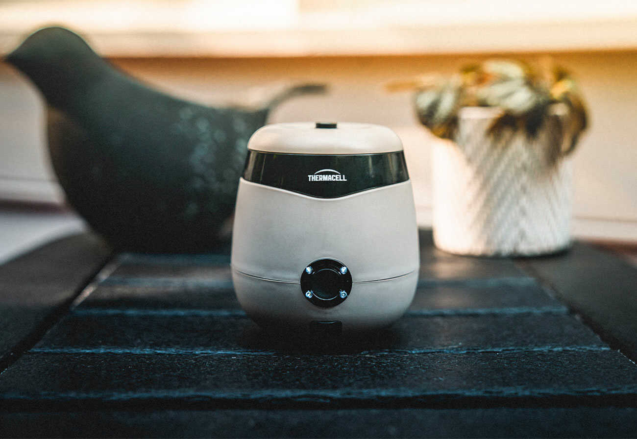 White Thermacell Mosquito Repeller on a black outdoor table. 