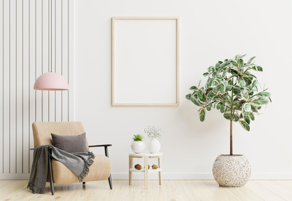 A room painted with a warm-white paint and furnished with a tan armchair and indoor plant.