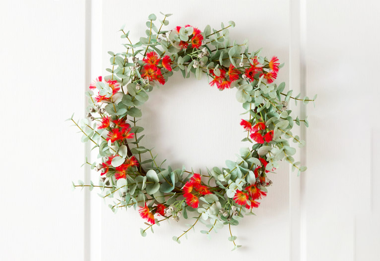 Eucalyptus and red flower festive door wreath.