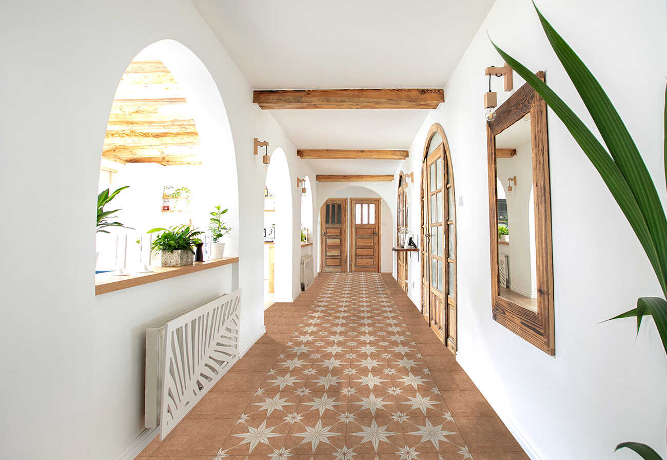 Decorative star tiles in a terracotta colour at entrance to a house.