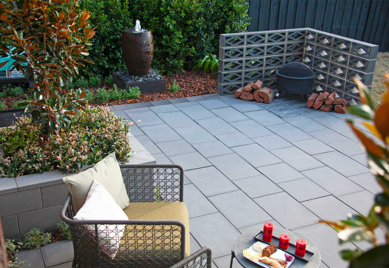 A garden courtyard with paving and a water feature.