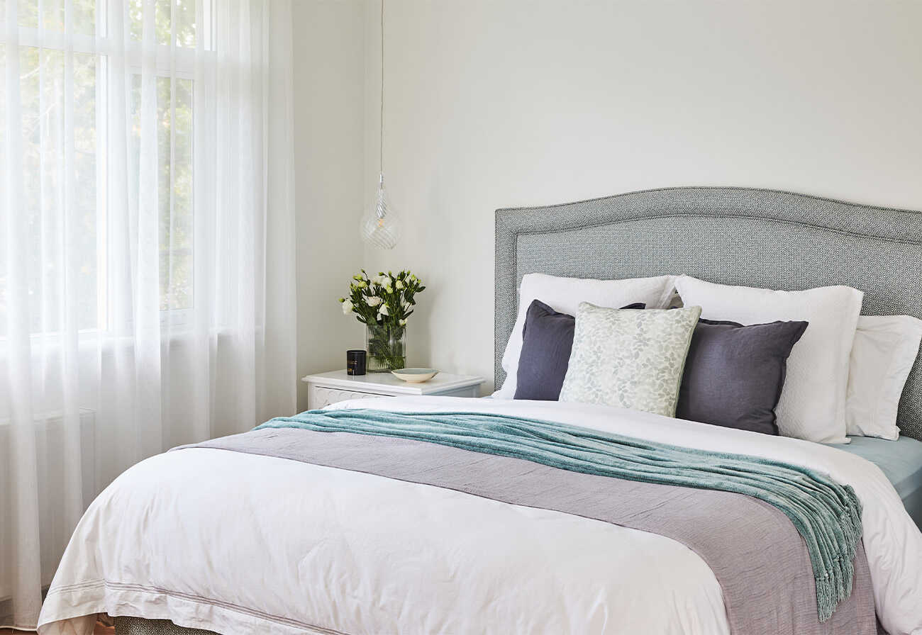 Master bedroom positioned adjacent to a window for good feng shui.