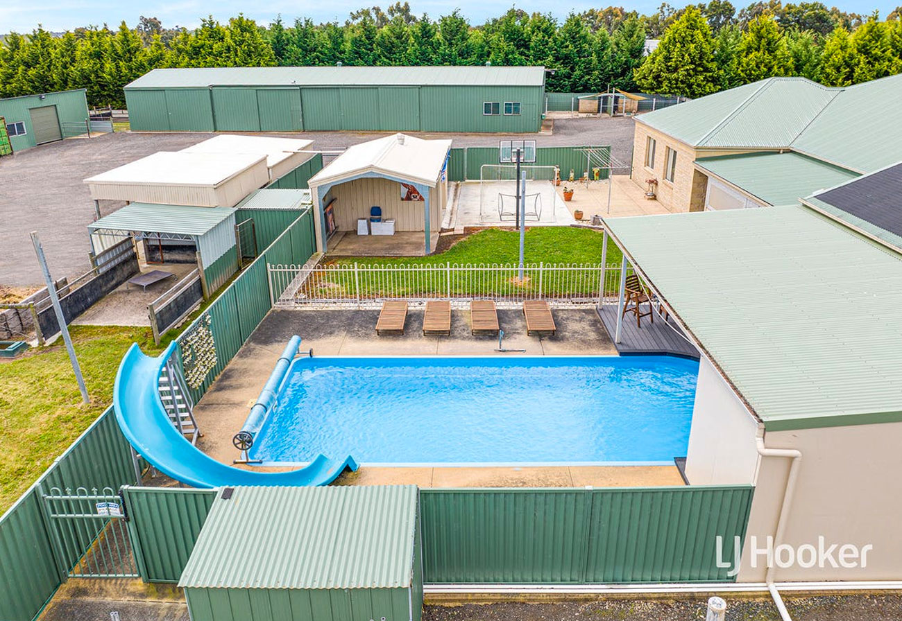 Pool with a waterslide at a country estate.